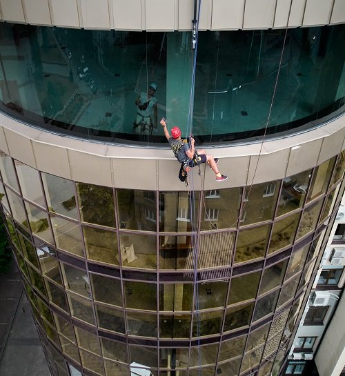 Technician performing window cleaning on a Union County - NJ home using detailed hand-finishing tools